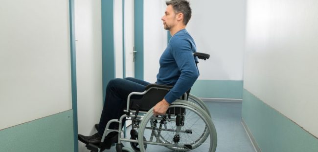 man in wheelchair at a door entryway